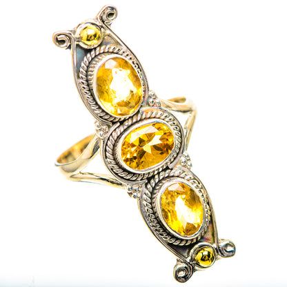 Silver citrine ring with three oval bezel-set stones and detailed twisted borders