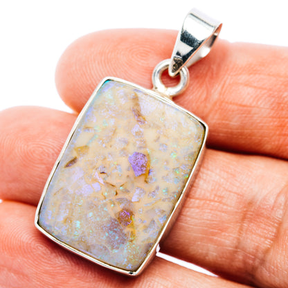 Sterling silver opal pendant with rectangular bezel and round bail, iridescent light stone.