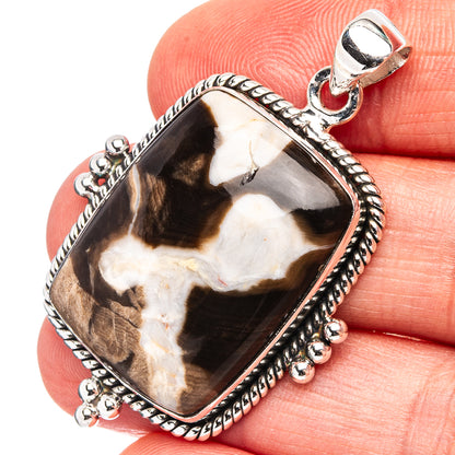 Sterling silver jasper pendant with dark brown and cream stone, textured bezel and bail