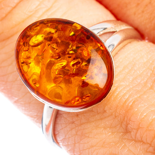 Amber cabochon set in a silver adjustable ring band
