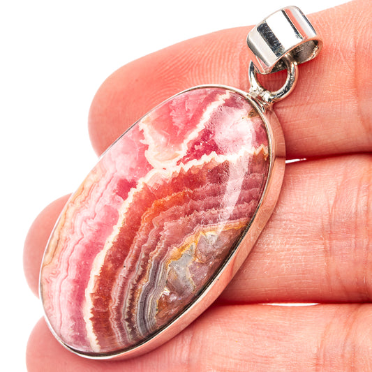 Oval rhodochrosite cabochon pendant, .925 sterling silver bezel and bail