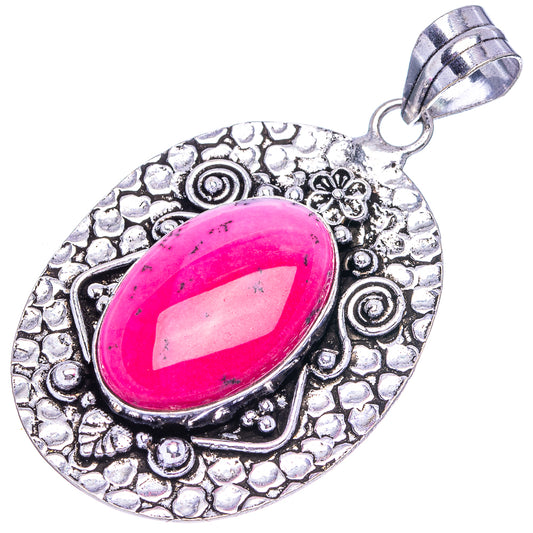 Pink oval opal pendant in silver-tone textured round setting with bail loop