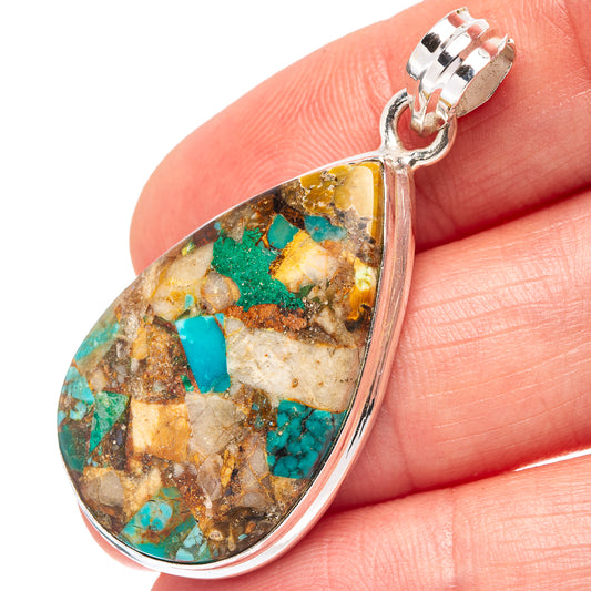 Teardrop chrysocolla matrix pendant detail in turquoise, gold, and brown with silver frame