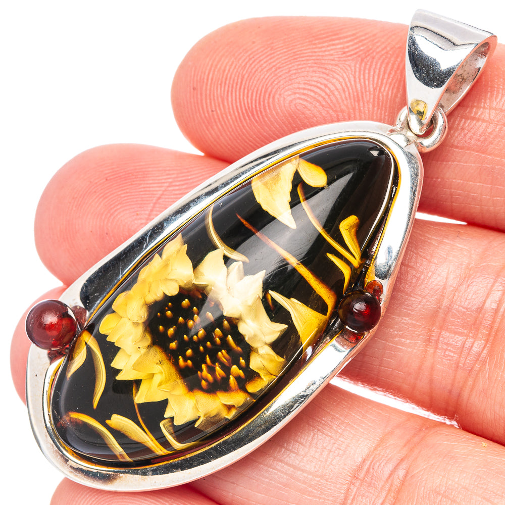 Oval amber intaglio sunflower pendant in sterling silver with red bead accents
