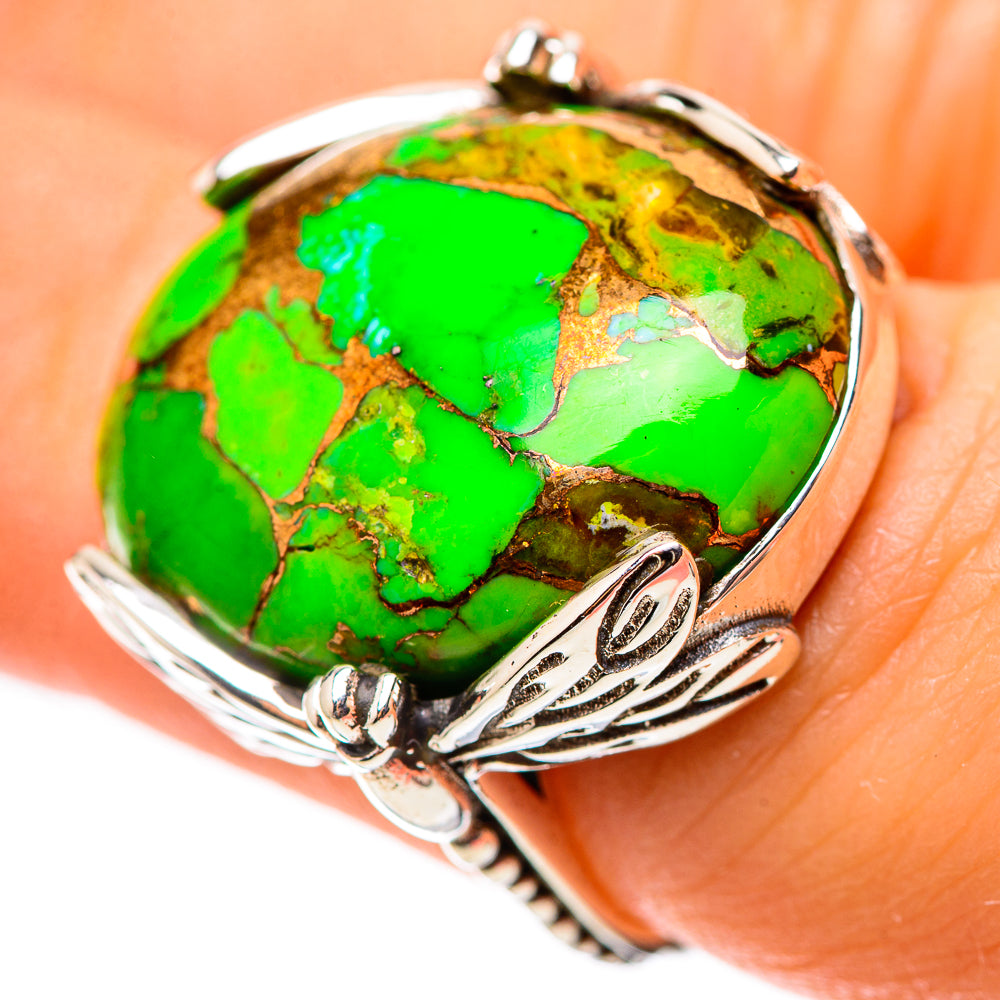 Green turquoise cabochon sterling silver ring worn on finger with decorative band