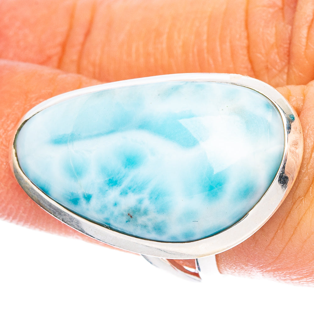 Oval Larimar cabochon sterling silver ring on hand, blue stone in silver bezel