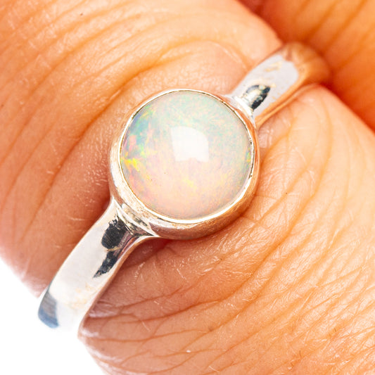 Sterling silver opal cabochon ring with oval light iridescent stone on band