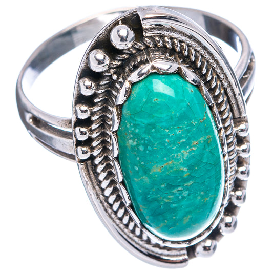 Turquoise oval cabochon sterling silver ring with detailed bezel and raised band