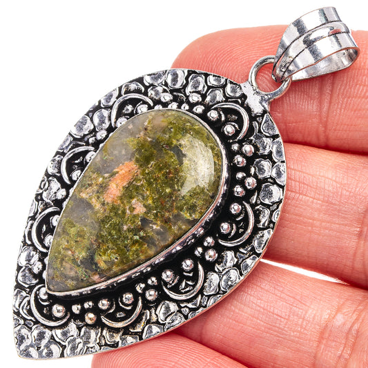 German silver unakite pendant with oval green-gold stone and ornate etched frame