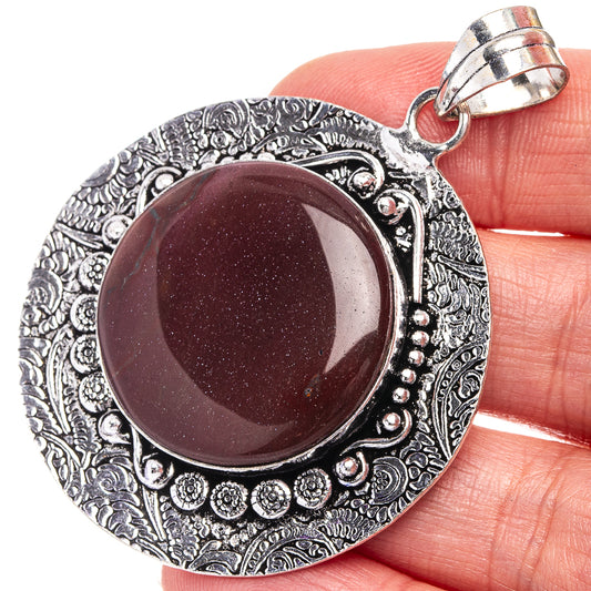 German silver pendant with maroon round gemstone and engraved border, hinged bail