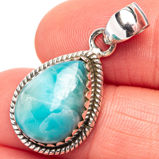 Close-up larimar teardrop pendant showing blue stone in ornate .925 silver rope frame