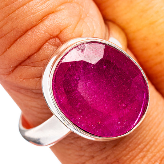 Sterling silver ring with round magenta ruby glass top set, worn on finger