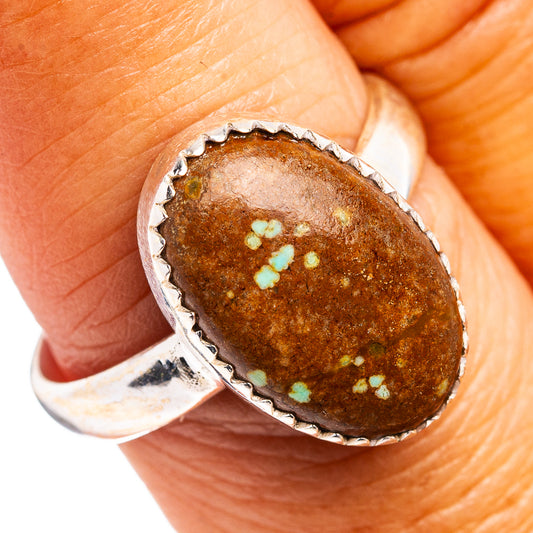 Sterling silver ring with oval brown gemstone and turquoise speckle bezel
