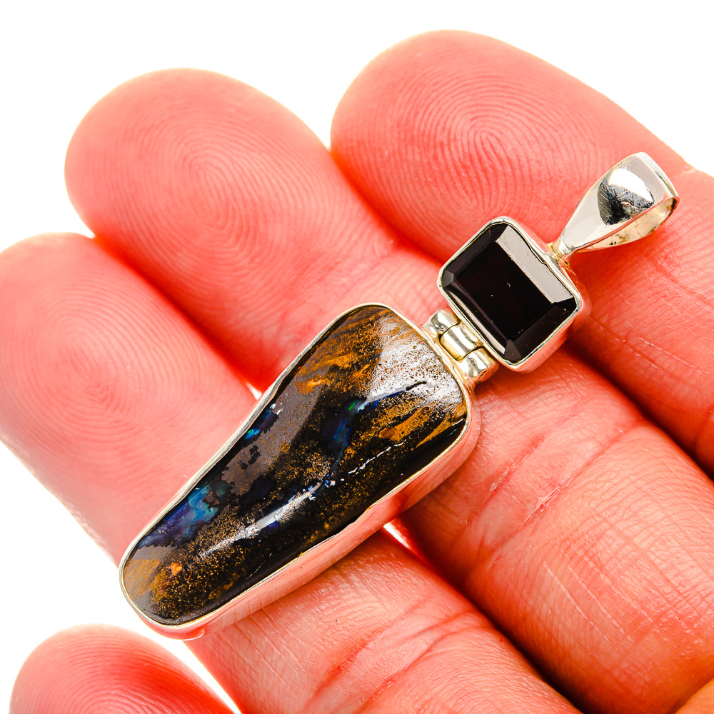 Sterling silver opal boulder pendant with black rectangular center stone, gold-toned bail
