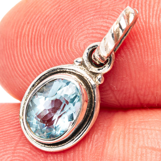 Sterling silver blue topaz oval pendant with raised bezel and loop bail