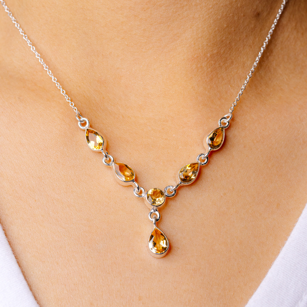 Sterling silver citrine necklace with faceted oval gemstones and teardrop pendant
