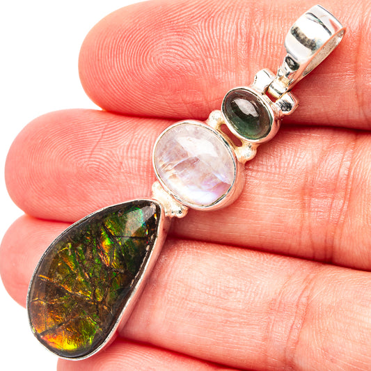 Sterling silver pendant close-up with ammolite drop, moonstone, and green tourmaline bezel