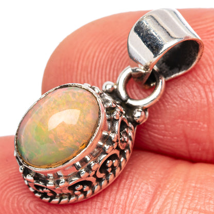 Oval opal pendant in ornate 925 sterling silver setting with hinged bail