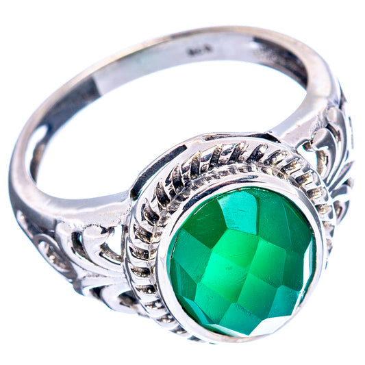 Sterling silver ring featuring green oval gemstone with detailed bezel and side scrollwork