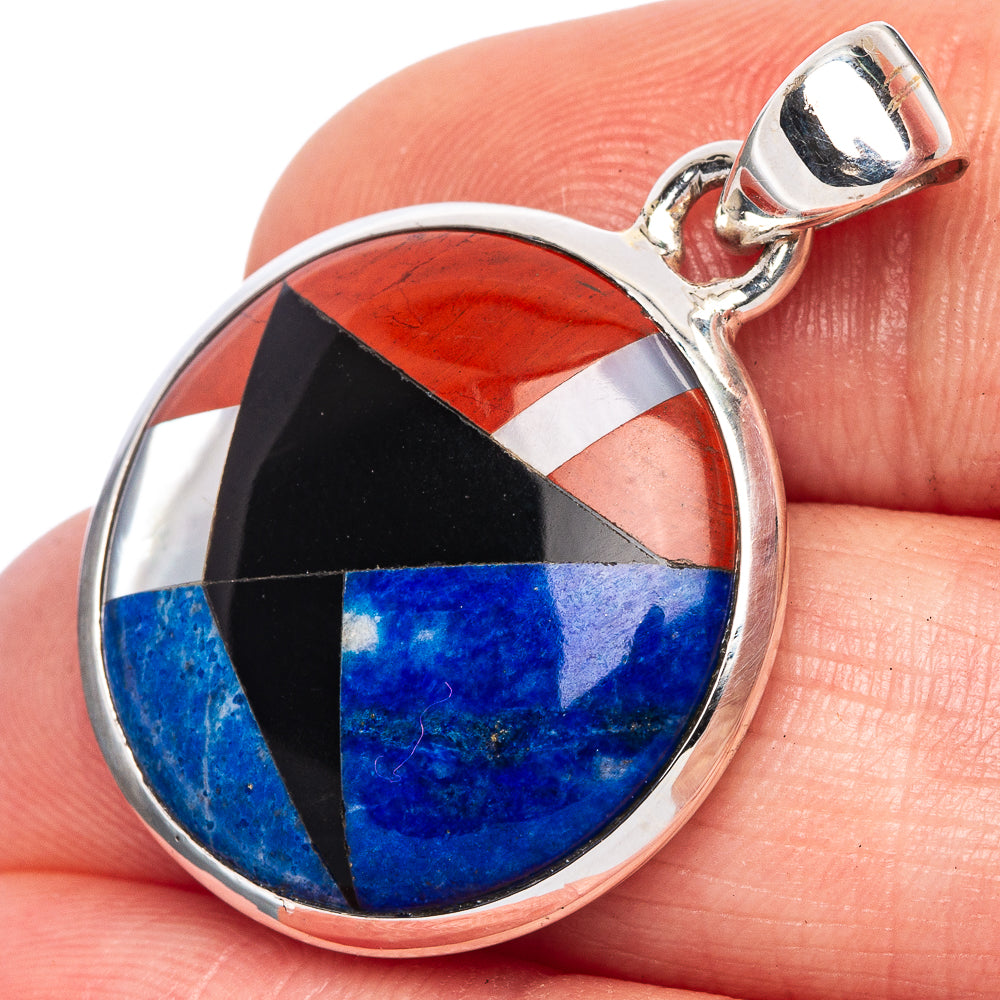 Round silver pendant with multi-stone inlay in red, black, white, and blue, with bail