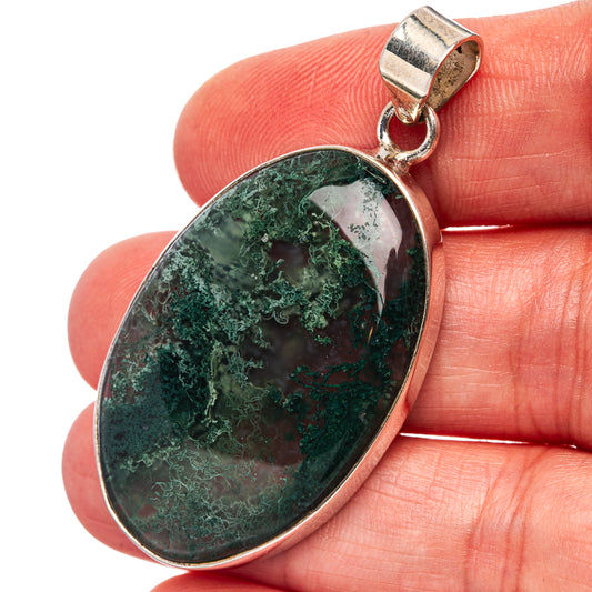 Close-up oval green moss agate pendant in sterling silver bezel with loop bail