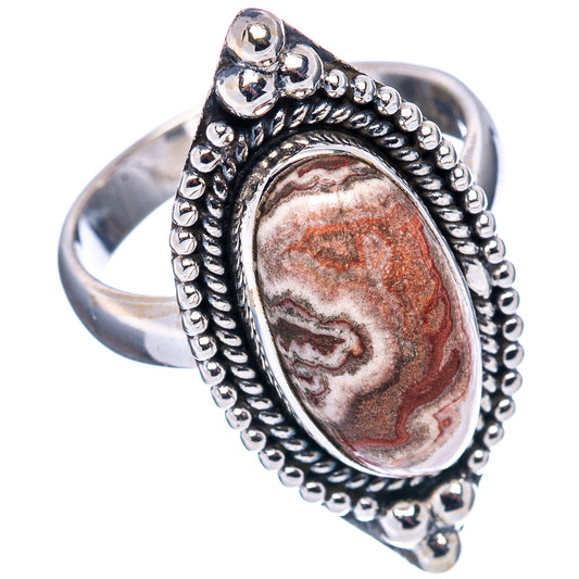 Sterling silver oval agate ring with beaded frame and swirling red, white pattern.