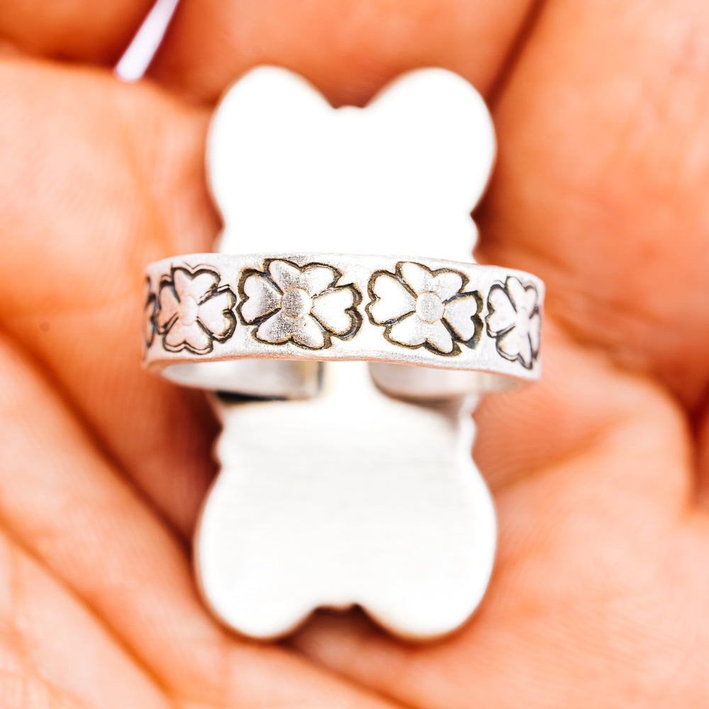 Sterling silver band with engraved floral cutout pattern
