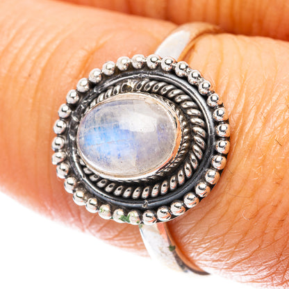Sterling silver ring with oval rainbow moonstone cabochon and beaded halo detail
