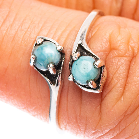 Sterling silver ring with a round blue larimar cabochon and bezel setting