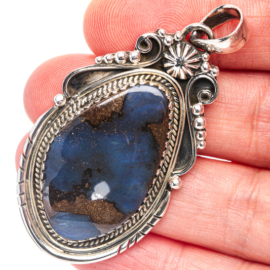 Sterling silver boulder opal pendant with oval blue stone, ornate bezel and bail