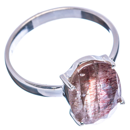 Sterling silver ring with oval dark red gemstone, four prongs, and polished band