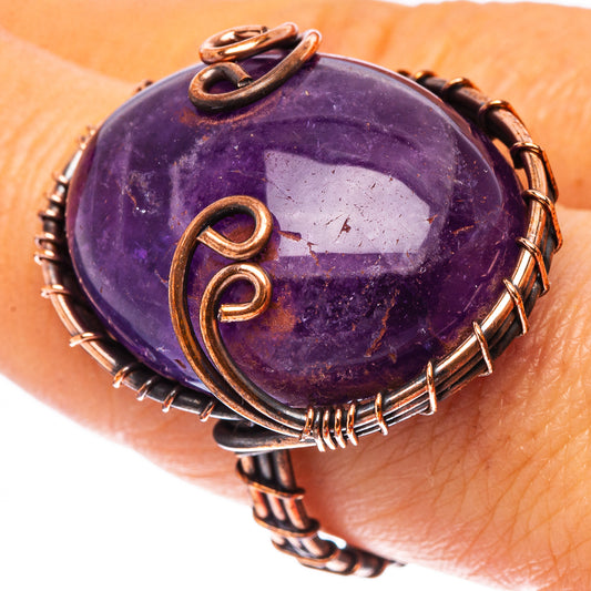 Oxidized copper wire wrap ring with purple amethyst oval cabochon, swirl accents