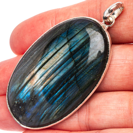 Oval labradorite pendant, dark gemstone with blue flash and silver-plated bail