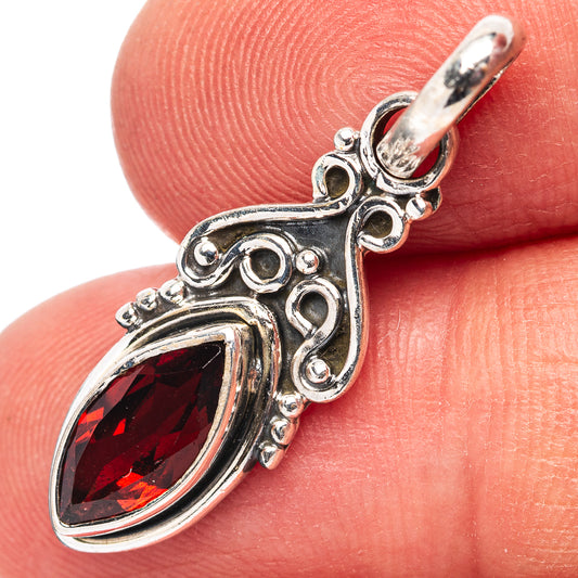 Sterling silver garnet pendant close-up with marquise red gemstone and loop bail