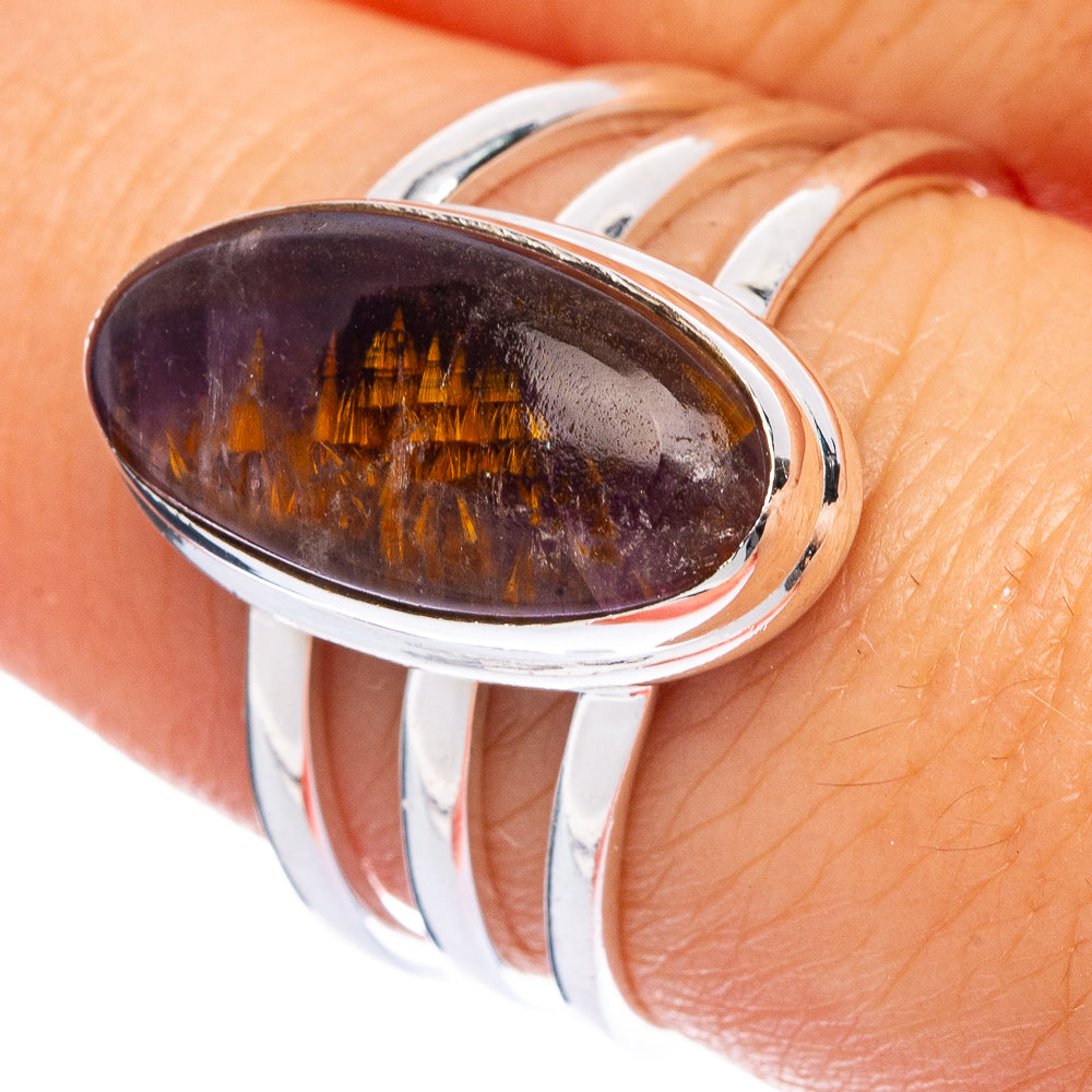 Sterling silver oval gemstone ring with dark purple cabochon and amber streaks