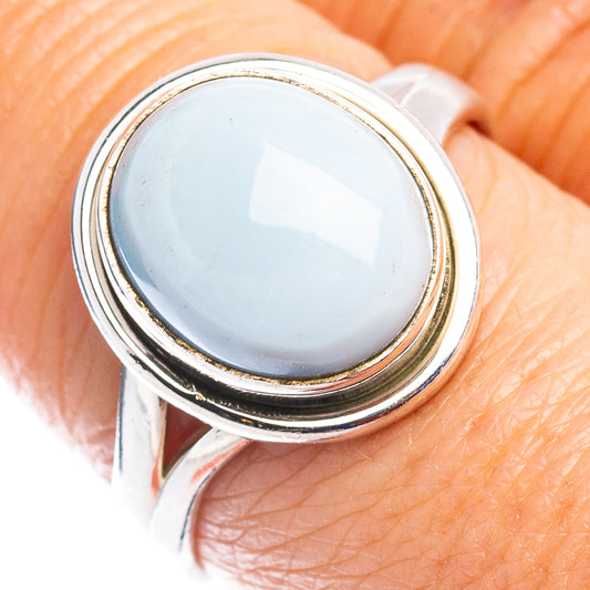 Sterling silver oval gemstone ring with pale blue stone bezel set