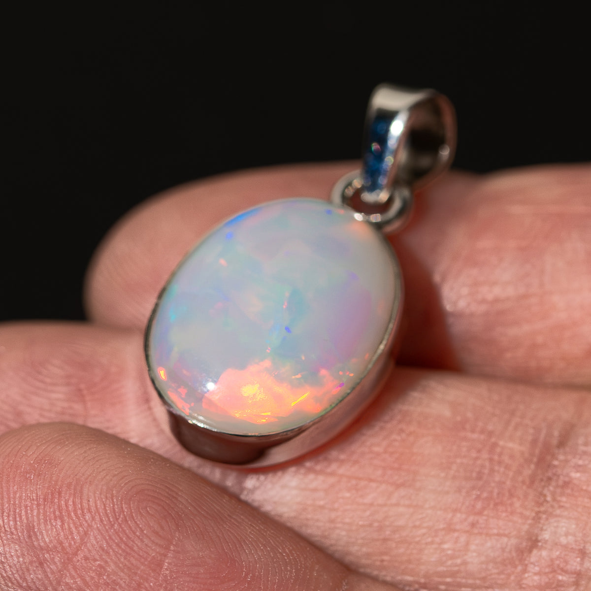 Oval opal pendant with .925 sterling silver bail and colorful iridescent surface