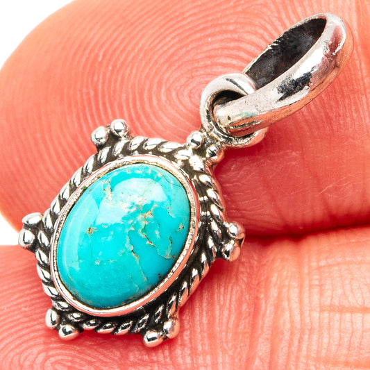 Turquoise oval pendant with ornate .925 sterling silver edges, close-up on bail