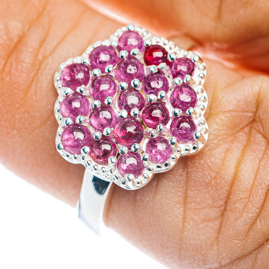 Sterling silver ruby cluster ring with round pink gemstones, halo border