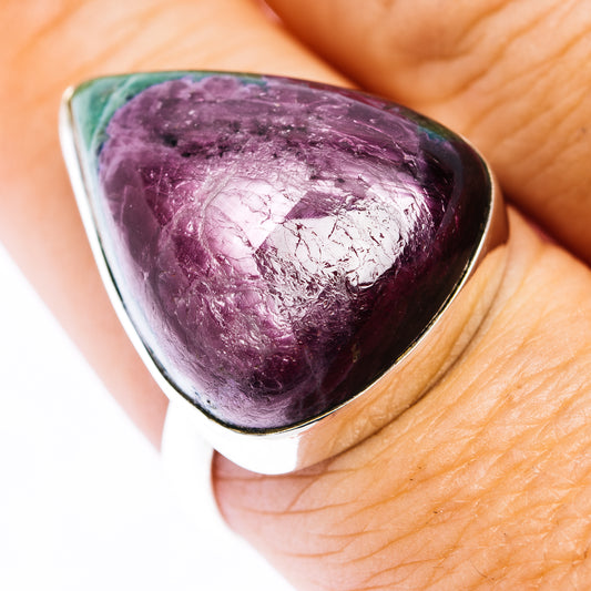 Sterling silver ring with a large polished purple and green triangular gemstone, shown on a finger.