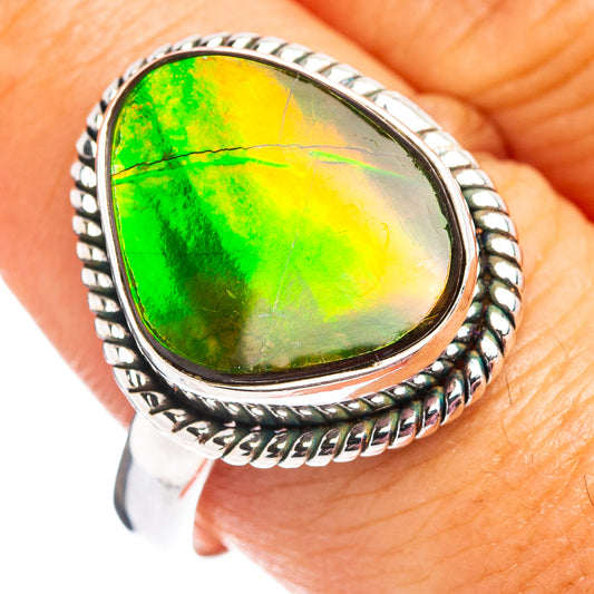 Sterling silver ammolite ring with oval green iridescent stone and rope border setting