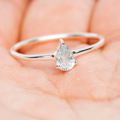Blue topaz stackable ring, .925 sterling silver band with teardrop gemstone on finger