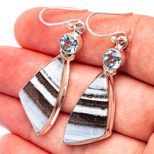 Sterling silver drop earrings with blue topaz centers and striped opal-like panels