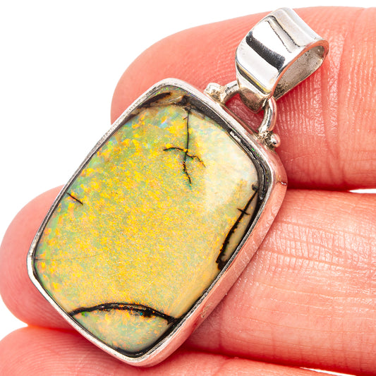 Sterling silver opal pendant with oval stone in bezel setting, close-up detail