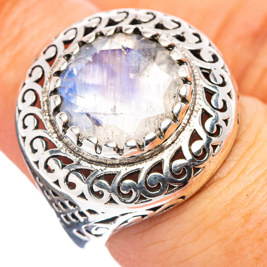 Sterling silver moonstone ring with iridescent oval stone and ornate filigree bezel