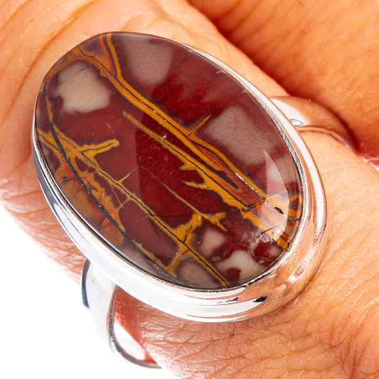 Oval jasper cabochon set in sterling silver band on finger close-up
