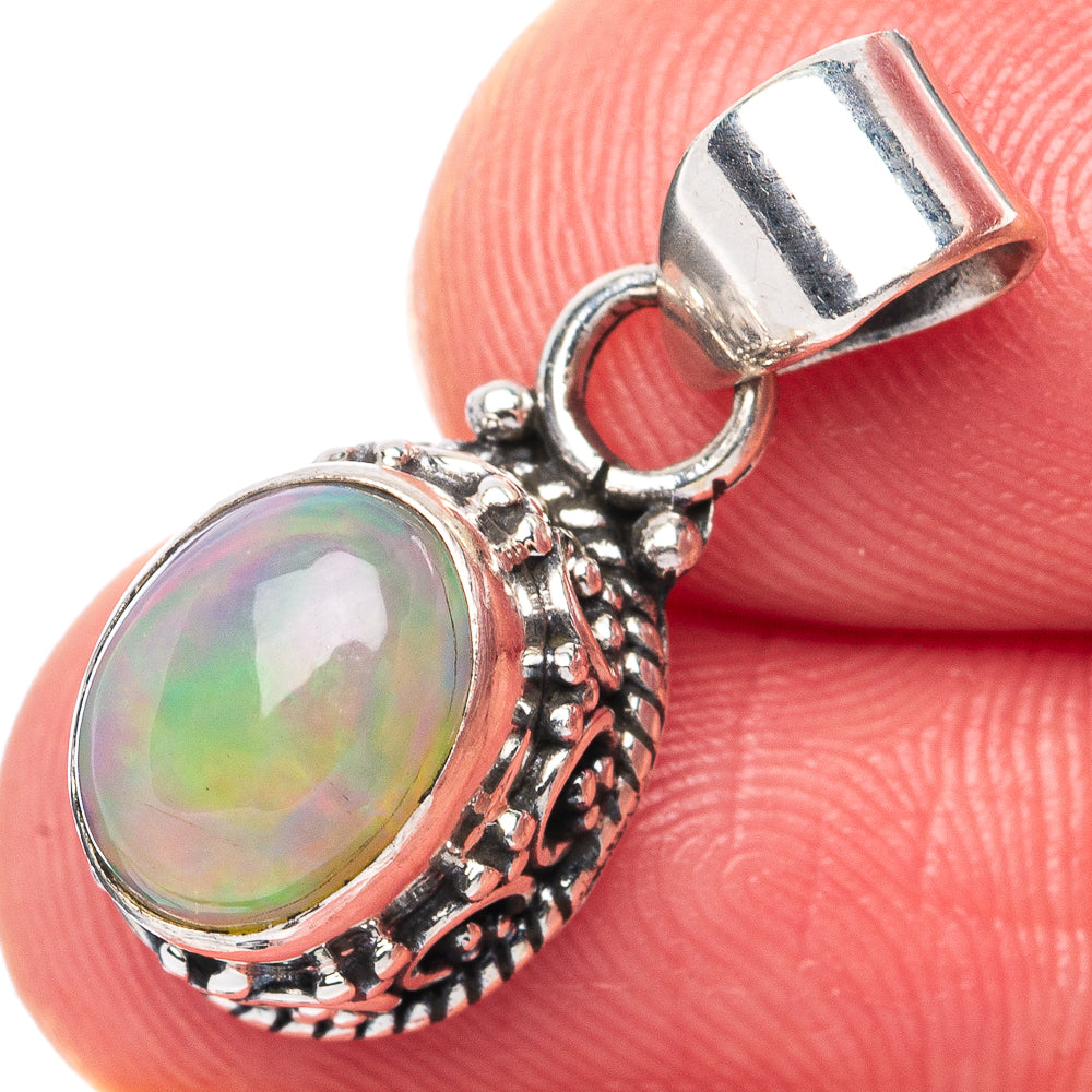Oval Ethiopian opal pendant with rainbow iridescence, ornate 925 sterling silver setting