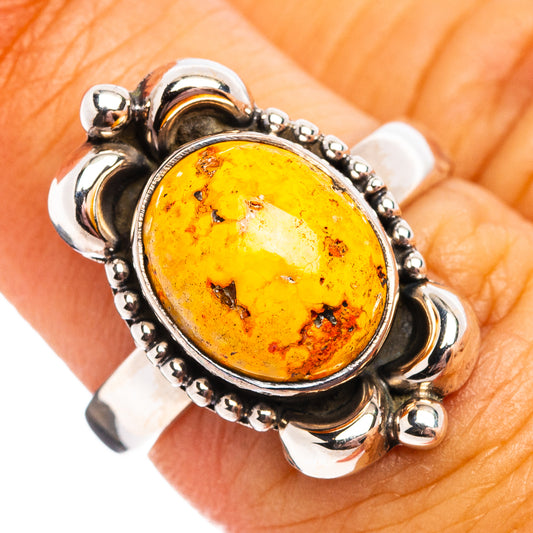 Sterling silver ring with oval amber gemstone, scalloped bezel and raised setting