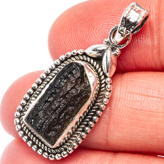 Sterling silver moldavite pendant with dark green stone in ornate bezel setting