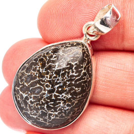 Oval .925 sterling silver dinosaur bone pendant with dark speckled texture and bail
